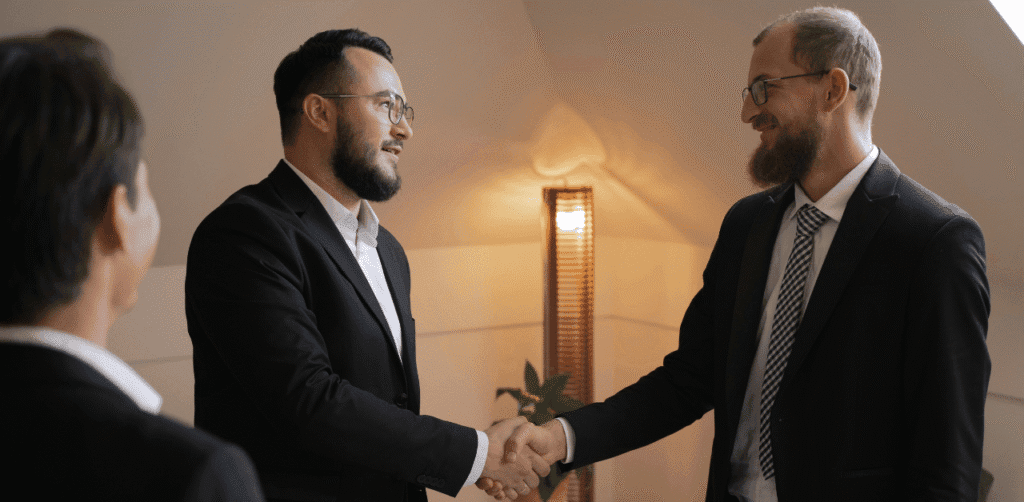 Business deal handshake representing partnership with Notecrest Capital in business note transactions