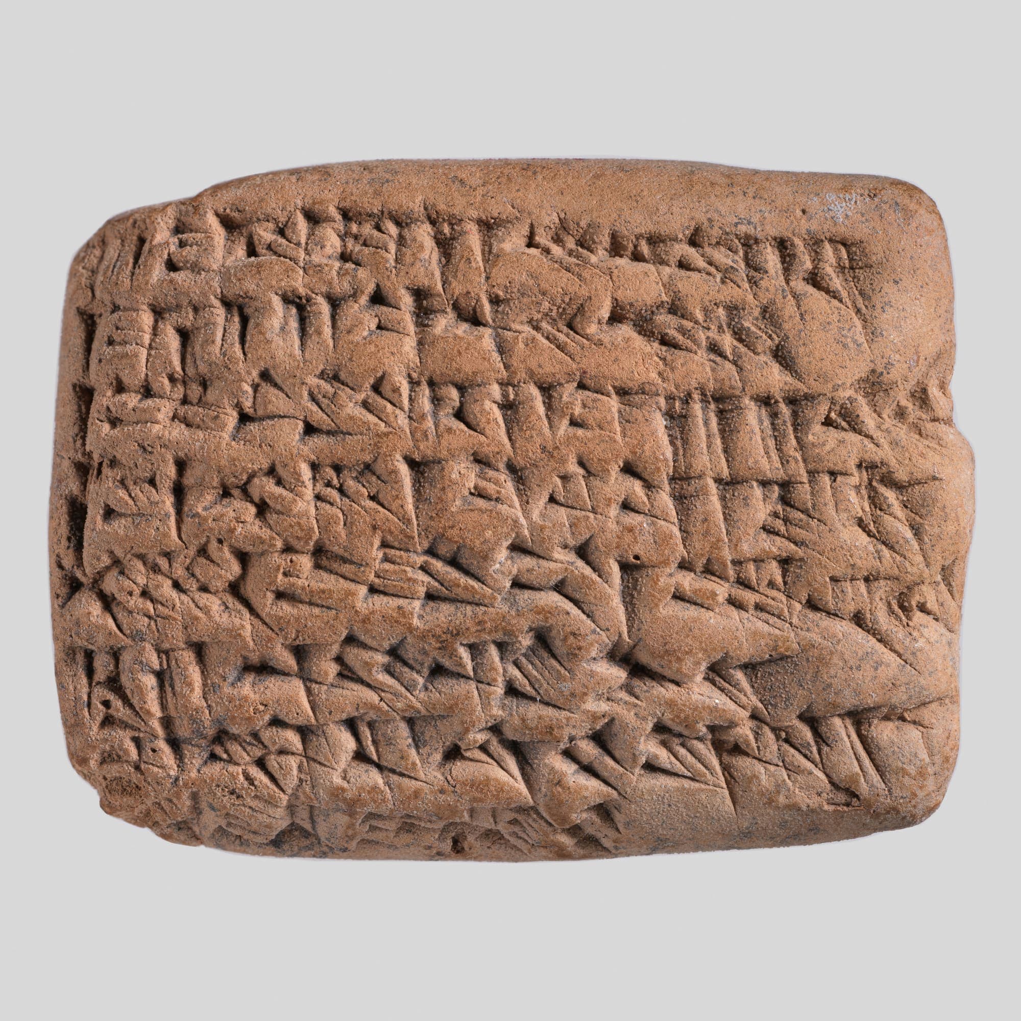 A small clay tablet covered in lines of cuneiform script