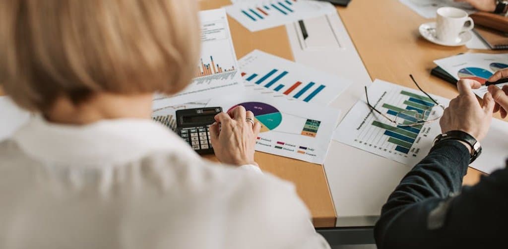 Acquisition due diligence team reviewing target business cash flow and debt-service coverage ratio