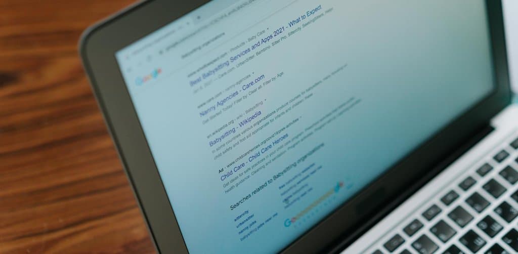 Laptop browser showing search results, the typical interface for a self-directed business lien search via state Secretary of State portals