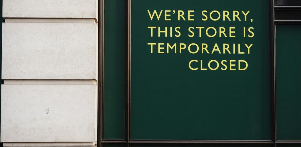 Storefront with temporary closure sign showing what a default on business loan collateral can look like in practice