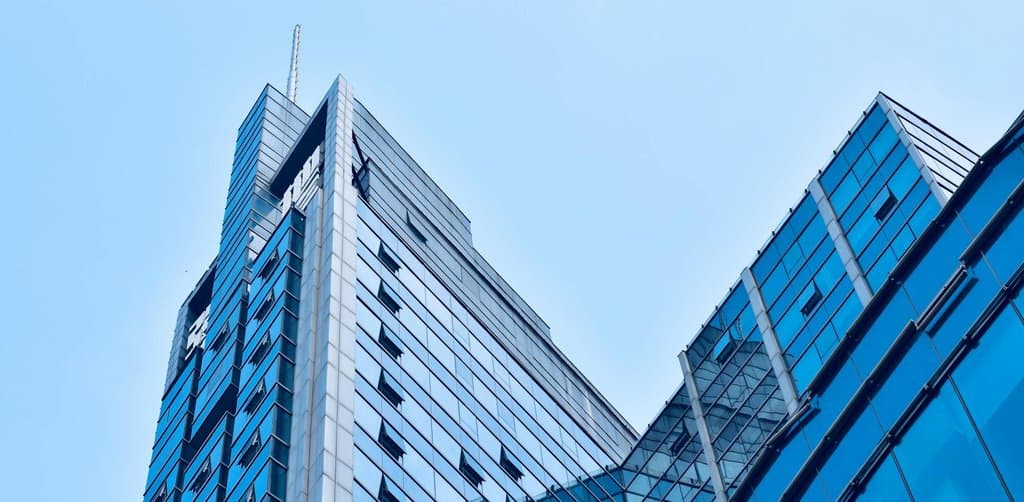 Glass office tower representing institutional capital structure in mezzanine financing for small business acquisitions