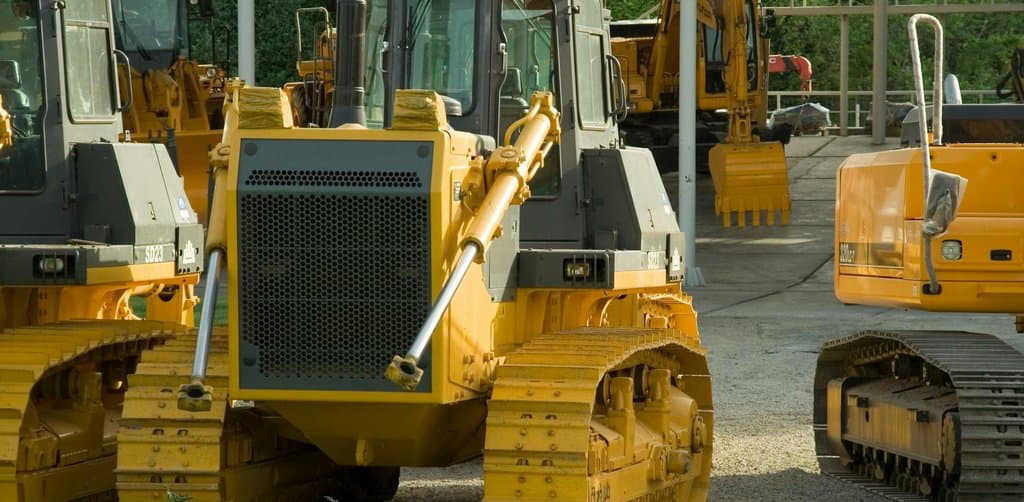 A yard of construction bulldozers and excavators, the kind of capital equipment most often financed through term business lending