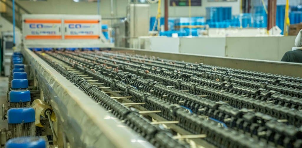 Manufacturing production line representing the broad scope of assets swept up under a blanket UCC lien rather than a specific UCC lien